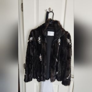 Fur coat with jewelry detail